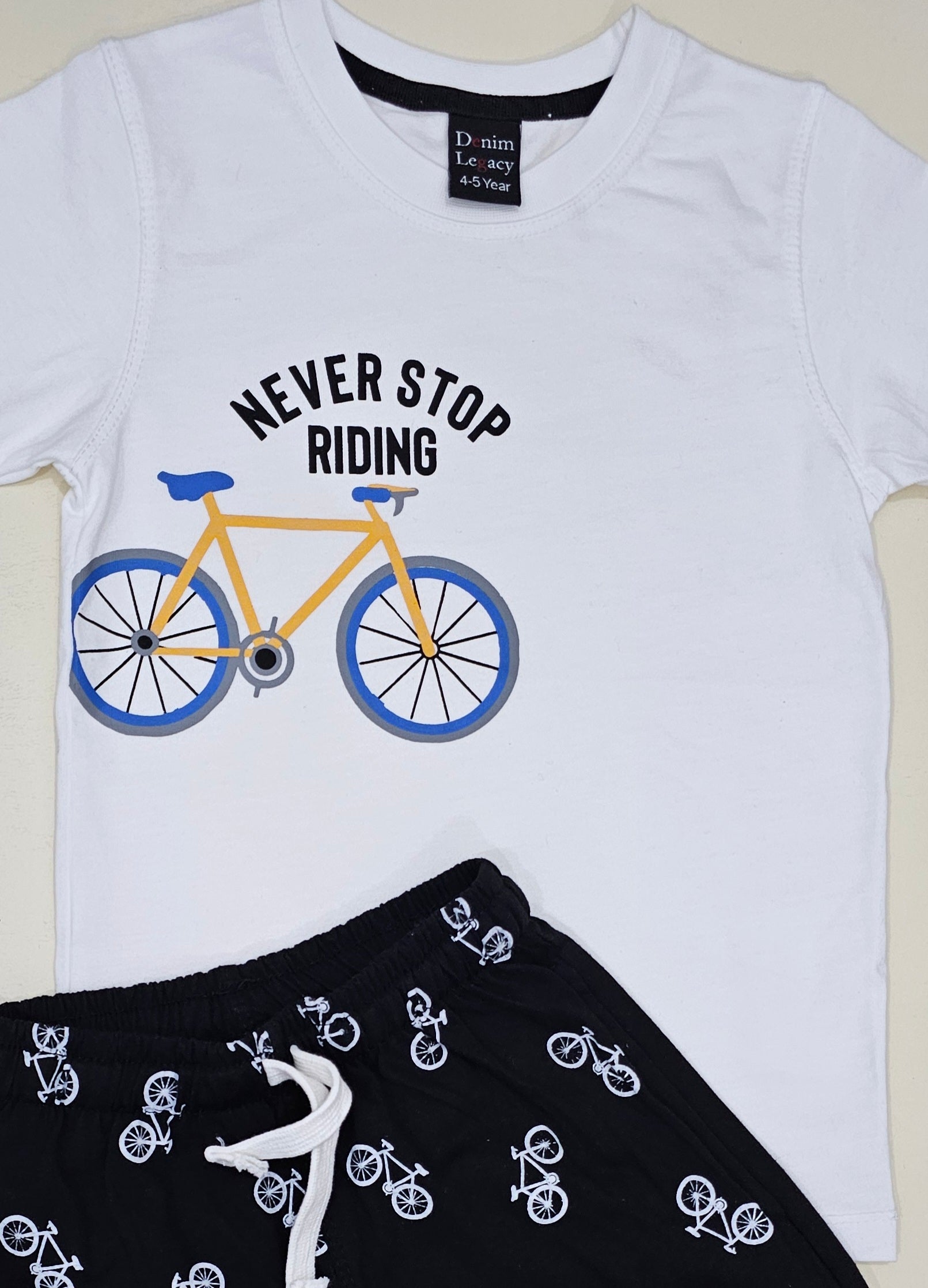 White Tshirt with black shorts, Never stop riding Boys Suit with Shorts in Cotton jersey fabric.